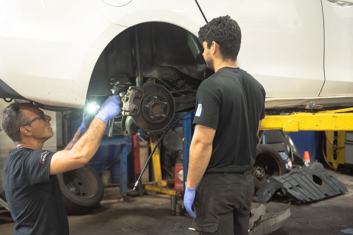 Technician inspecting a vehicle during a digital inspection in Oakville